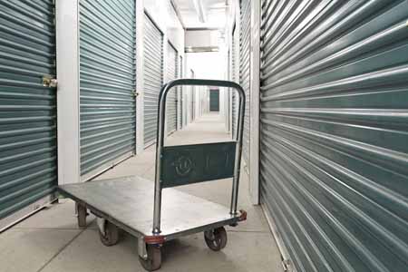 Moving cart inside of a hallway of a storage facility.