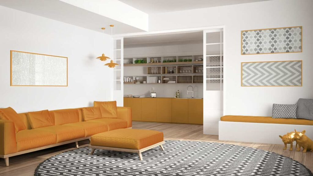 A neat room with an orange couch, and  a clean rug