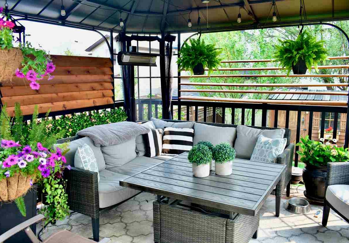 A patio with string lights, plants, and nice summer furniture.