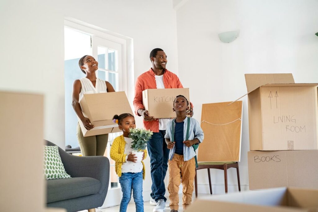A family moving boxes into their new home