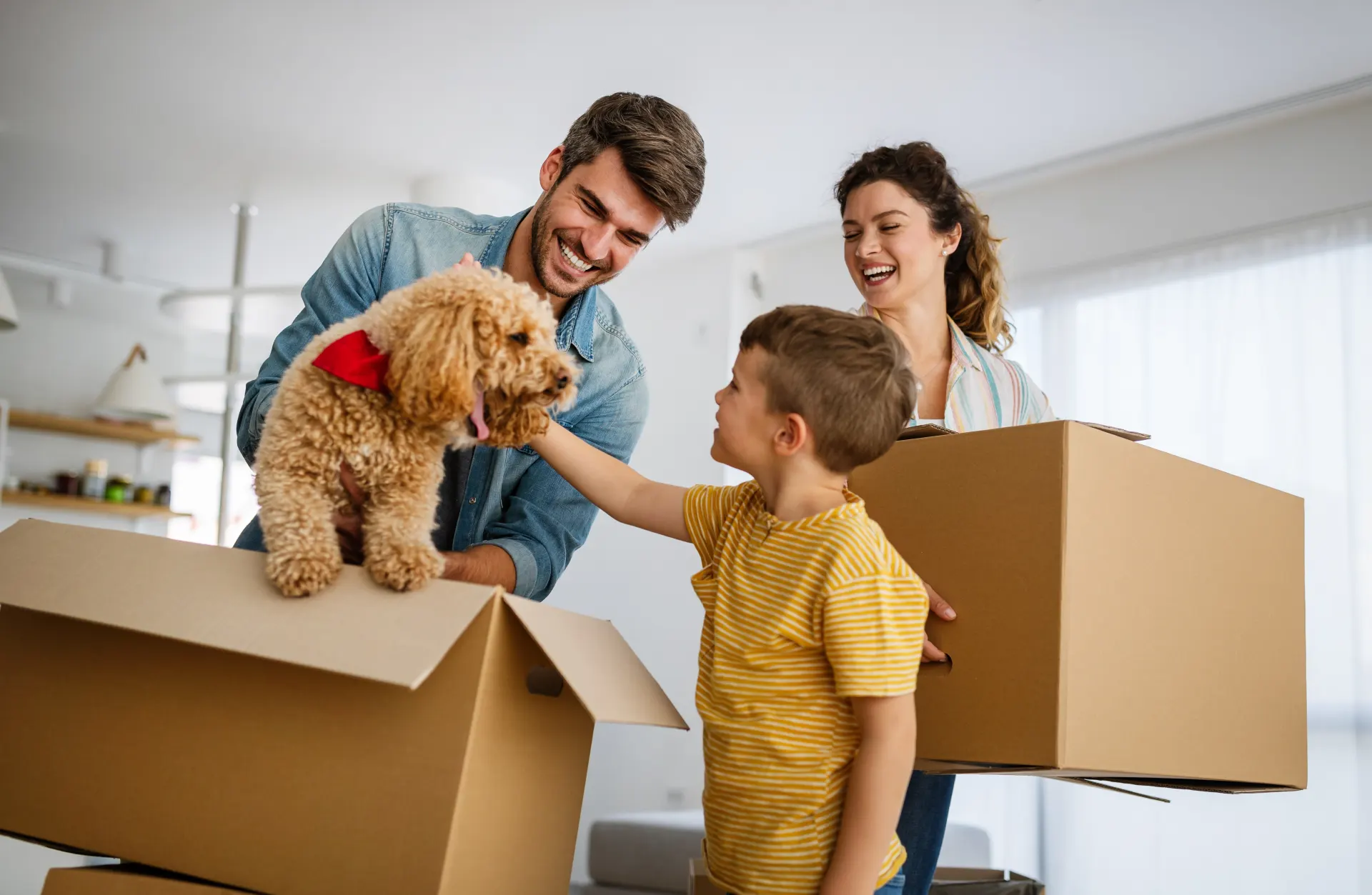 Photo of a family with moving boxes in their home.