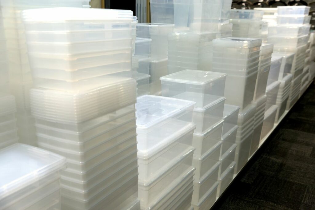 Clear, plastic storage containers in various sizes stacked in rows