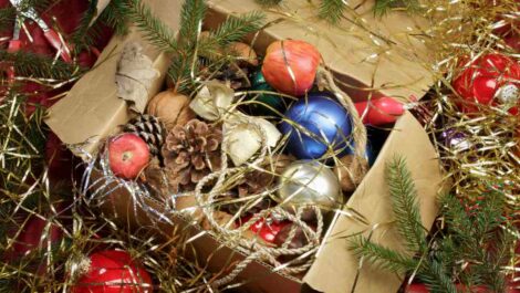 Tinsel and ornaments in a festive box of holiday decorations