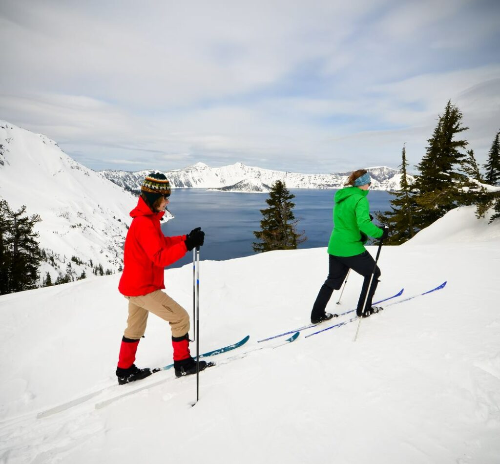 Two women cross-country skiing in Crater Lake National Park, OR